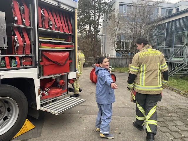 Die Feuerwehr zeigt der Schülerschaft den Leiterwagen.