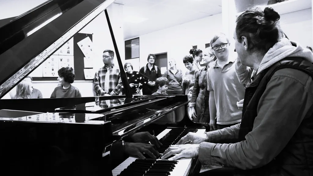 Davide Martello spielt für die Schülerinnen und Schüler am Flügel.